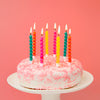 Rainbow birthday candles on glittery birthday cake | Talking Tables